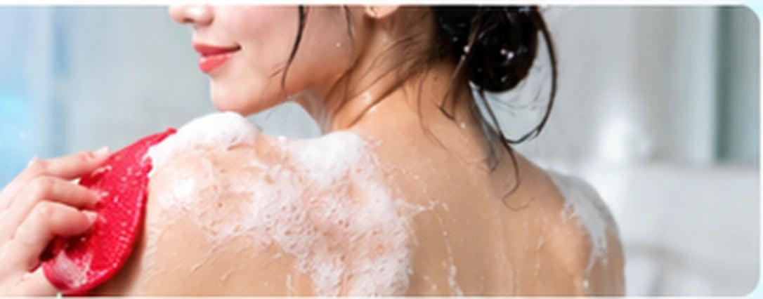 Body care shower scene with red exfoliating glove