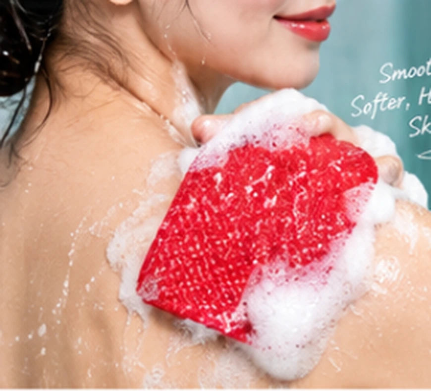 Red exfoliating glove used on shoulder in the shower